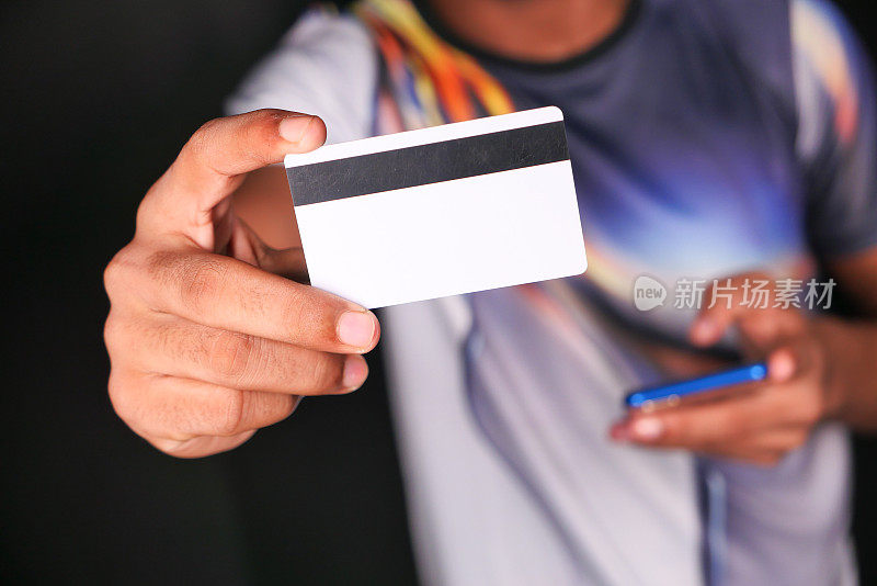 hand holding credit cards reading information